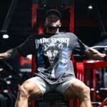 A man sitting on a bench in a gym